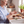 Load image into Gallery viewer, Woman using topical CBD Cream on arthritis hands after gardening CBD rub for pain on a kitchen counter with gardening gloves, soap and a nail brush in a sunny window where basil is growing.

